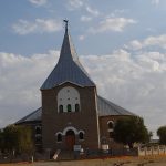 Kamieskroon has a fine church with many flowers in yard including white colchicum church